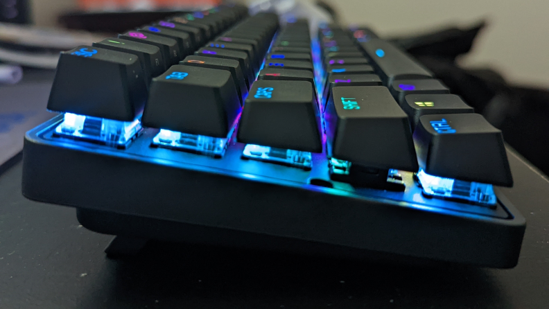 Side view of a keyboard showing blue lights illuminating the keys.