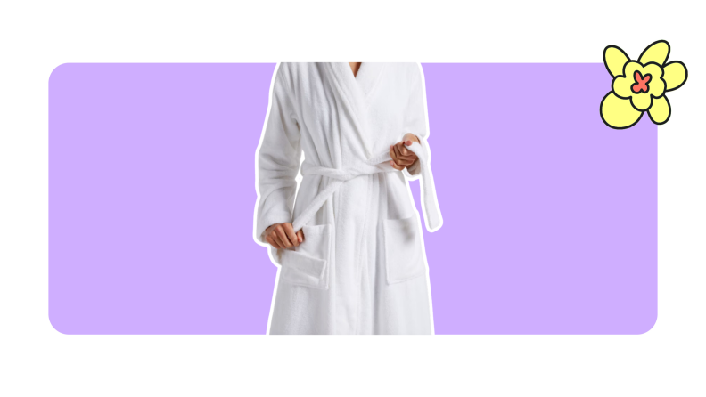 A person models a white Classic Turkish Cotton Robe by Parachute while pulling on the waist belt.