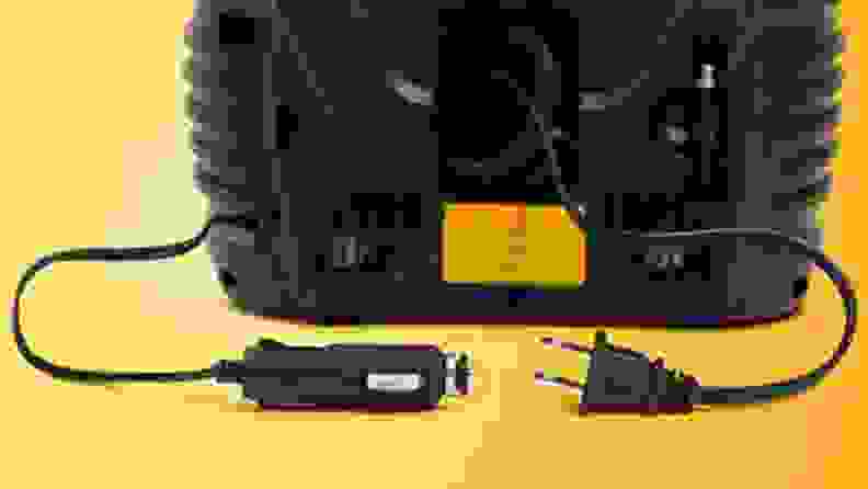 Wall plug and lighter adaptor of air compressor on yellow background