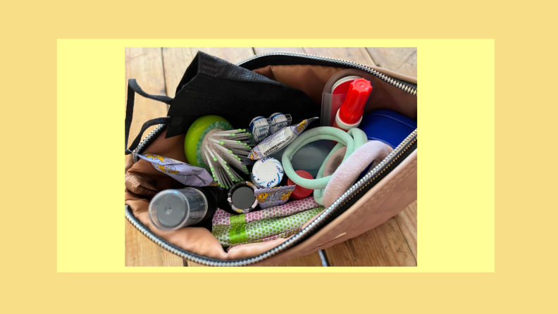 Small toiletry bag filled with assorted hygiene products.