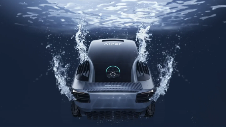 A sleek, black Scuba X1 Pro Max Pool Cleaner submerged in water, emitting bubbles and ripples as it operates, with a futuristic control panel visible on its surface.