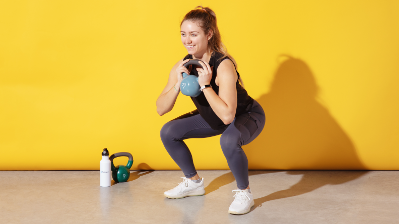 Woman lifting weight in Strongfeel shoes.