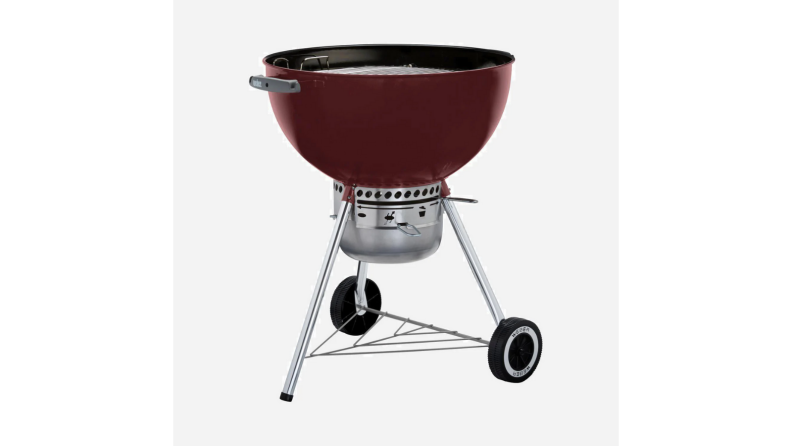 An image of a dark red charcoal grill on a gray background.