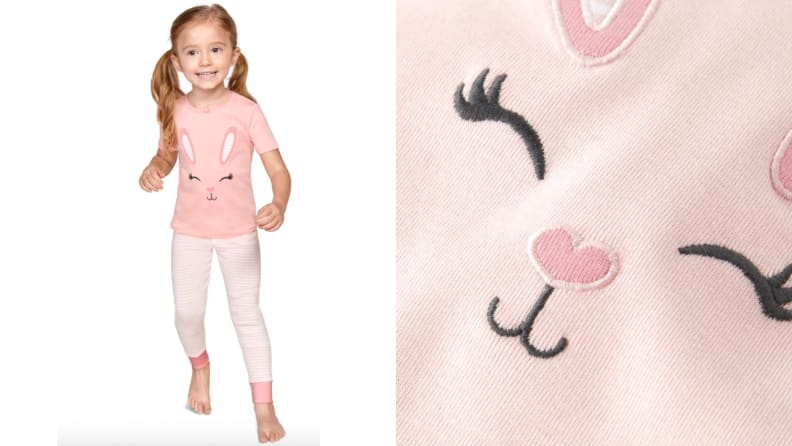 A girl is smiling in her bunny pajamas. The bunny is also smiling!