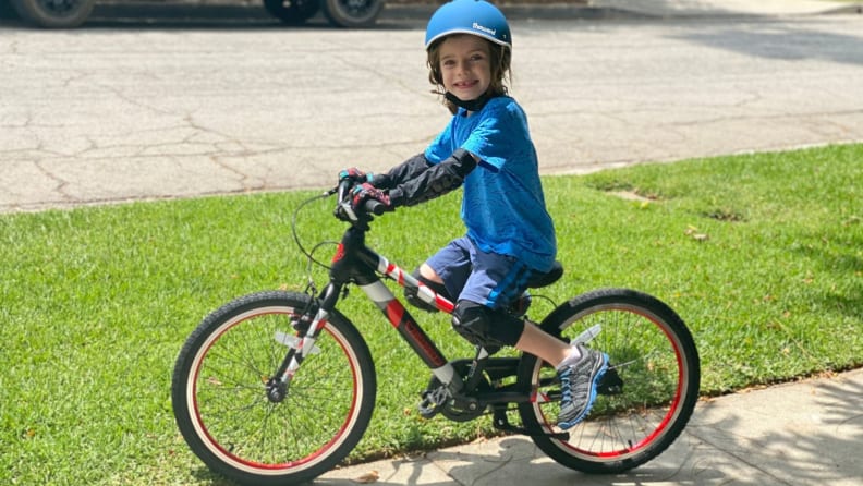 A boy smiling on a Guardian Kids Bike