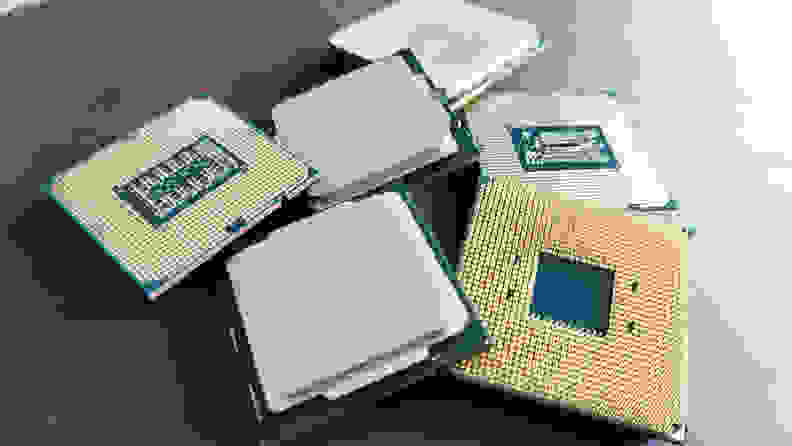 Several desktop computer processors laying a dark surface