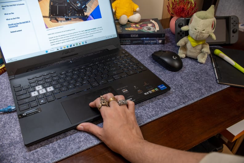 A person's hand on top of a laptop touchpad