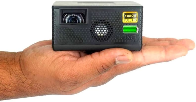 A outstretched hand holds the small AAXA P400 mini projector.
