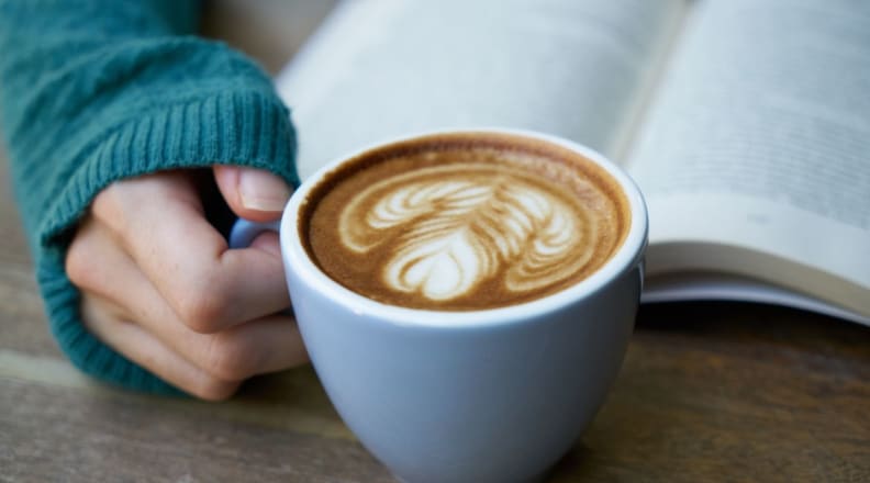 Person drinking coffee and reading