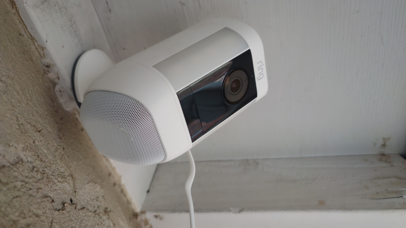 Product shot of the mounted Ring Spotlight Cam Pro security camera outside of home.