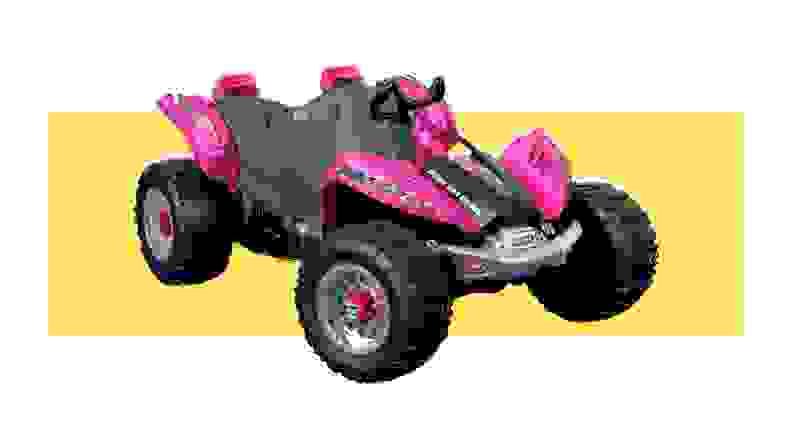 A pink Power Wheels Dune Racer on a yellow background.