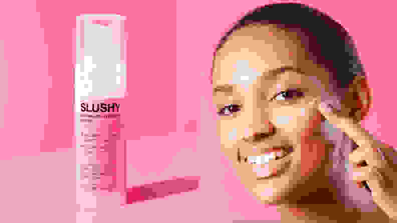On the left: A pink bottle of moisturizer on a hot pink background. On the right: A person applying moisturizer to their cheek with their index finger and smiling.