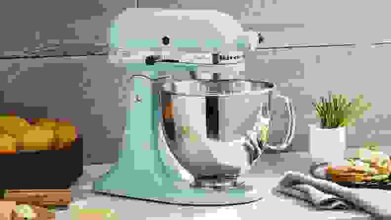 A blue stand mixer on an angle, revealing the lever.