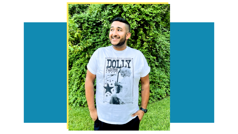 Person wearing a white Dolly Parton graphic t-shirt.