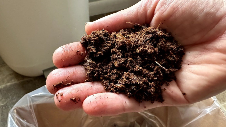 A hand holding recycled food.