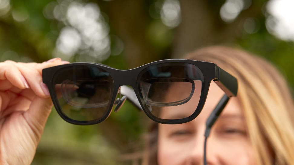 a woman holding augmented reality glasses