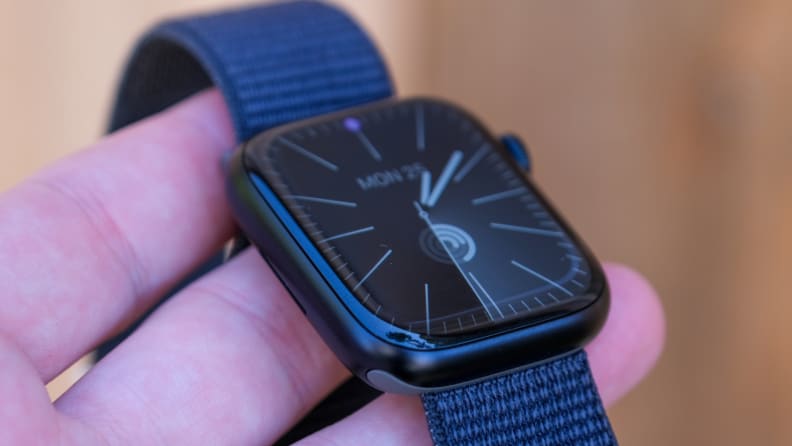 A reviewer shows the Apple Watch Series 9 to readers, allowing them to see its iconic design.