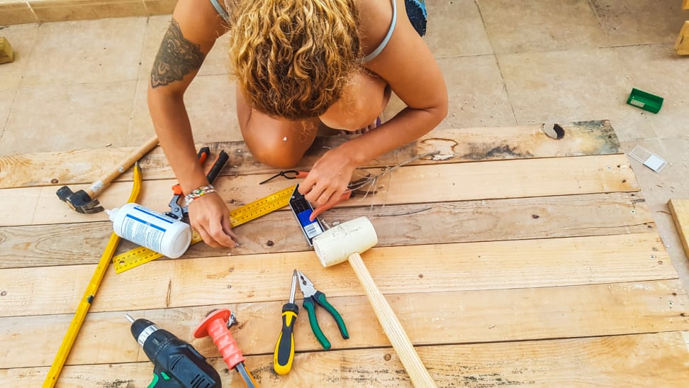 woman working on wood pallet project