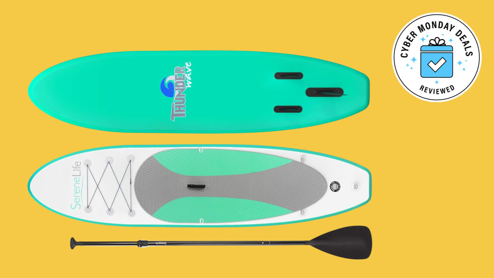 A SereneLife Inflatable Stand Up Paddle Board laid against a yellow background.
