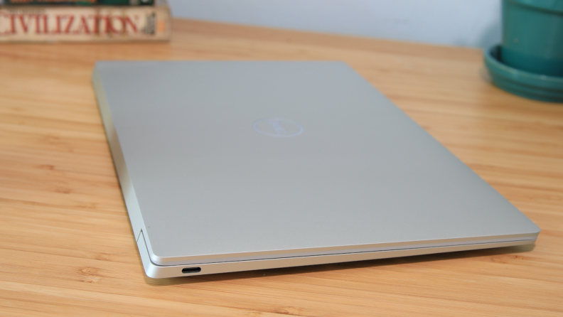 A closed silver laptop on top of a desk.