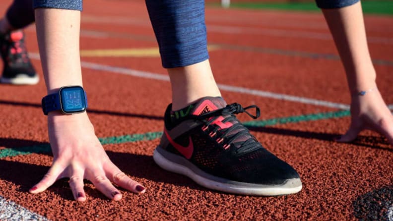 A close-up of a running shoe on a track.