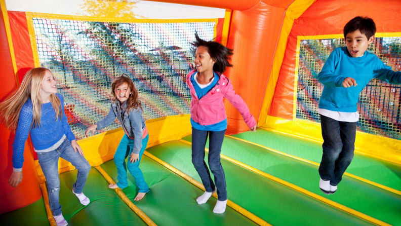 Kids pop into the bounce house at their birthday party.