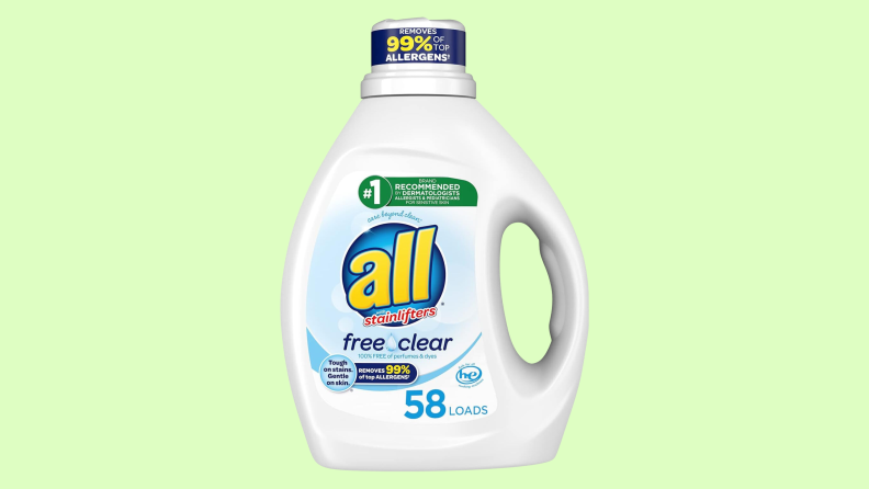 A bottle of All detergent with a slightly curved handle is pictured over a pale green field.