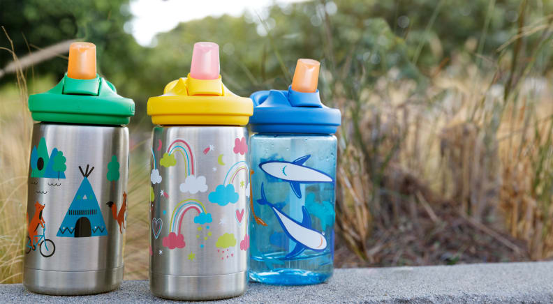 Three CamelBak bottles lined in a row. Two are stainless steel and one is BPA-free plastic.