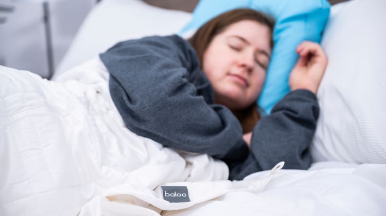 the camera is focused on the Baloo tag as Sara sleeps under it