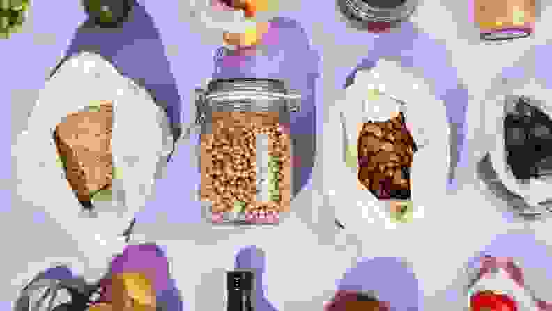 An assortment of pantry goods are neatly assembled on a surface.