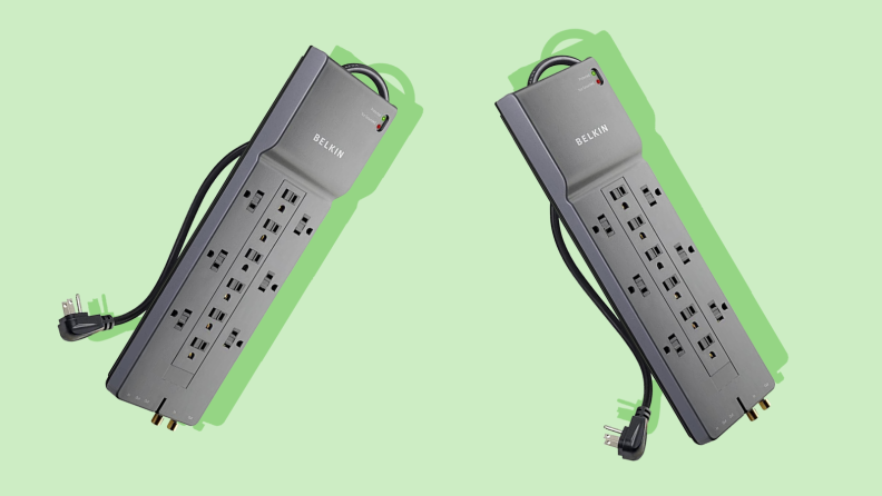 Two surge protectors against a green background.