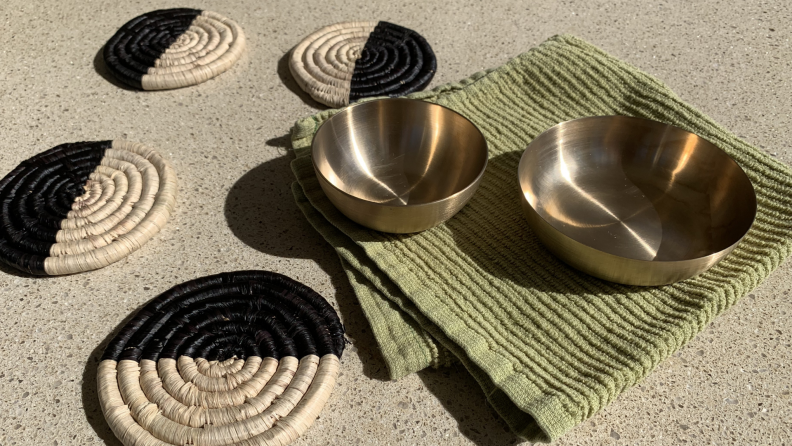 Coasters and bronze bowls with a glass and cashews