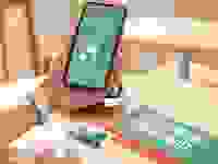Person holding smartphone displaying Mint Mobile on screen