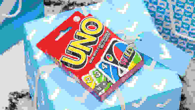 A box of Uno cards on a Reviewed gift box.