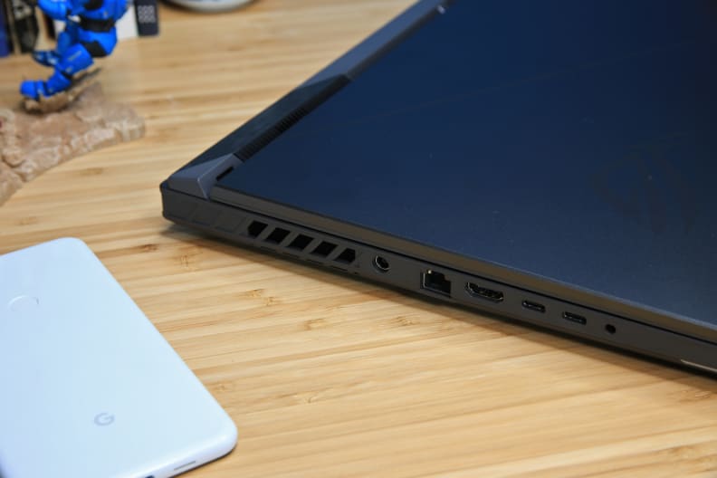 A black laptop on a light brown desk