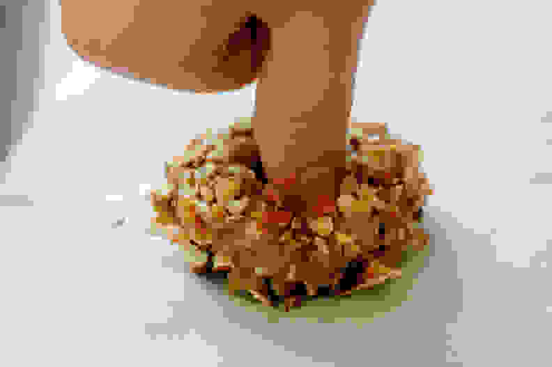 thumb making indent in cookie