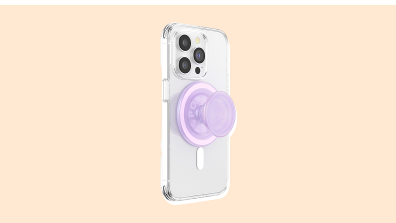 A Popsocket on the back of a smartphone on a vanilla-colored background.