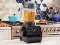 Vitamix blender filled with butternut squash soup on a kitchen countertop