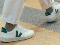 A model walking down the street in Veja sneakers.