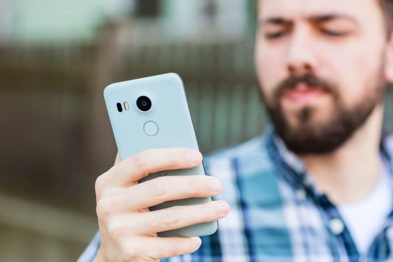 The Nexus 5X in a hand, as seen from the back.