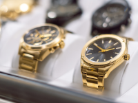 Gold watches in a display case.