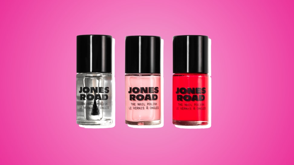 Collage of three nail polishes from Jones Road in clear, pink, and red against a magenta-colored background.