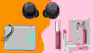 light blue wristlet, black earbuds and lip balm duo on an orange/pink background.
