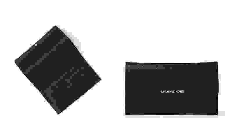 Black leather michael kors wallet on white background