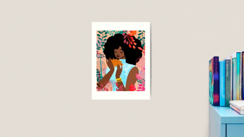 An image of an art print on a pale beige wall. The print depicts a Black woman in a turquoise top, surrounded by flowers.