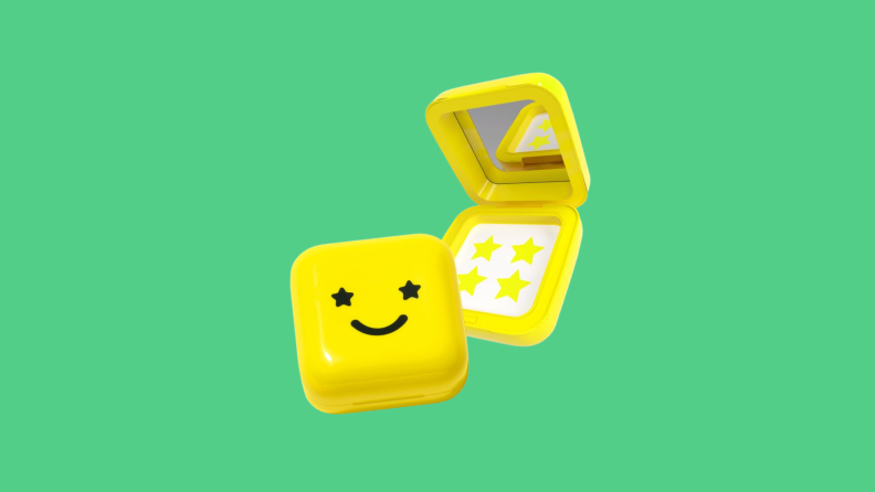 A yellow container, with stickers and mirror, of Starface pimple patches on a green background.