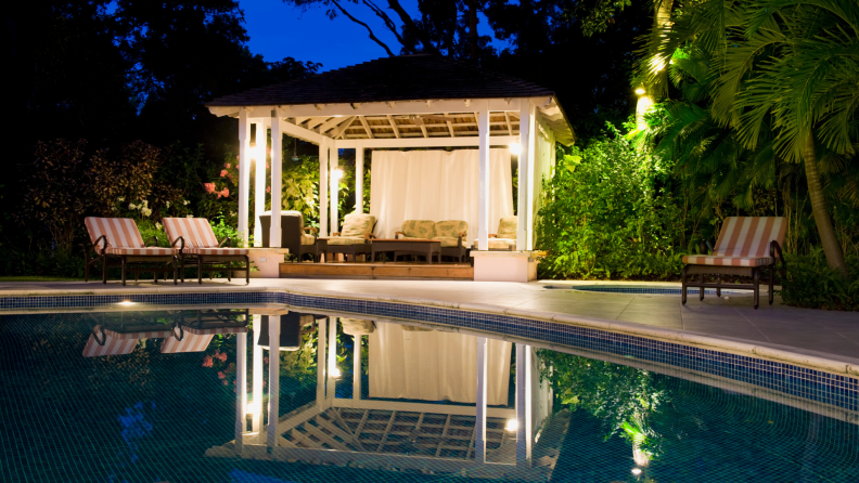 Bask in the glow of your outdoor pool cabana after enjoying a night swim.
