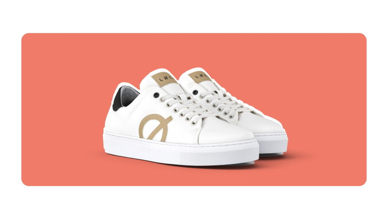 A white and tan pair of Løci Origin Sneakers laced up and angled to the side.