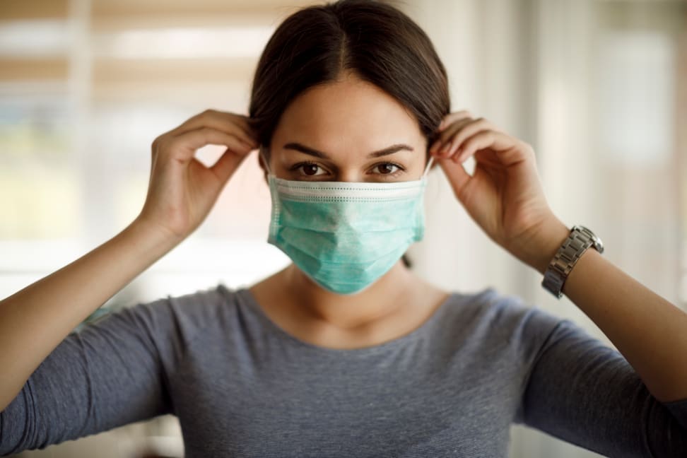 Woman putting on a face mask