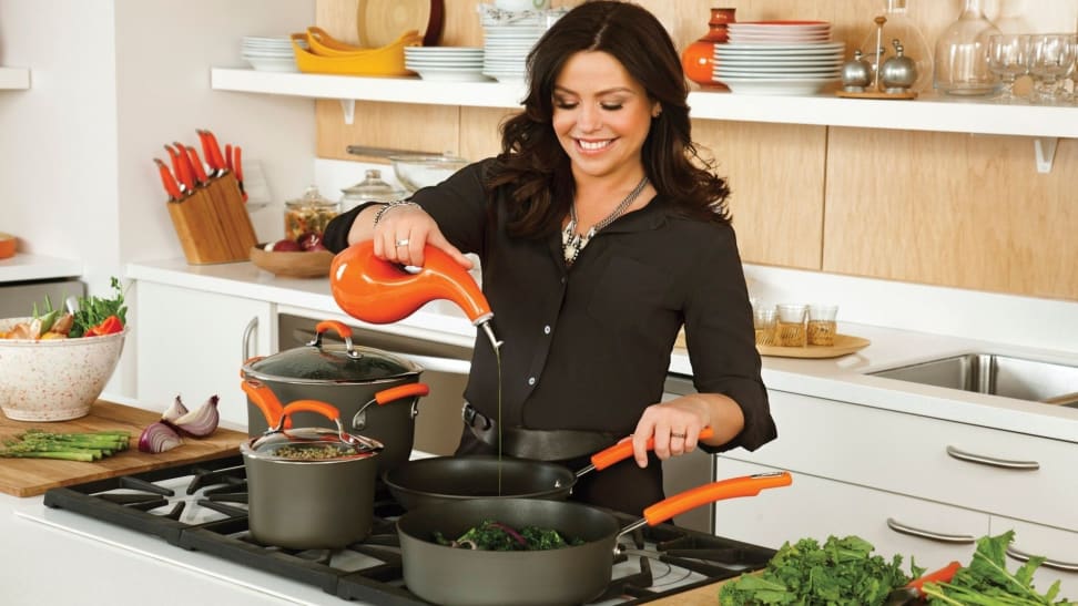 Rachael Ray cooks in a kitchen using her nonstick cookware set.